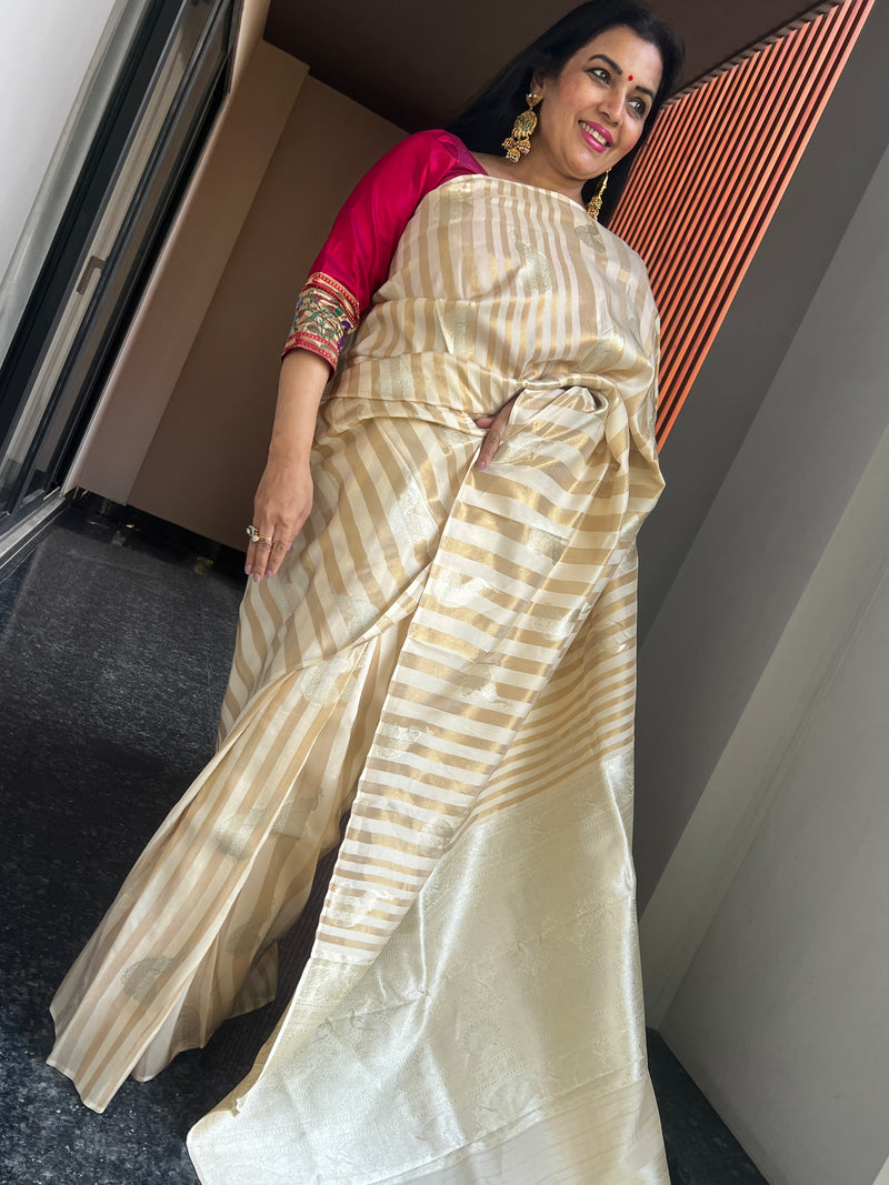 Graceful Beauty of a Cream Ektara Katan Silk Striped Saree with Peacocks